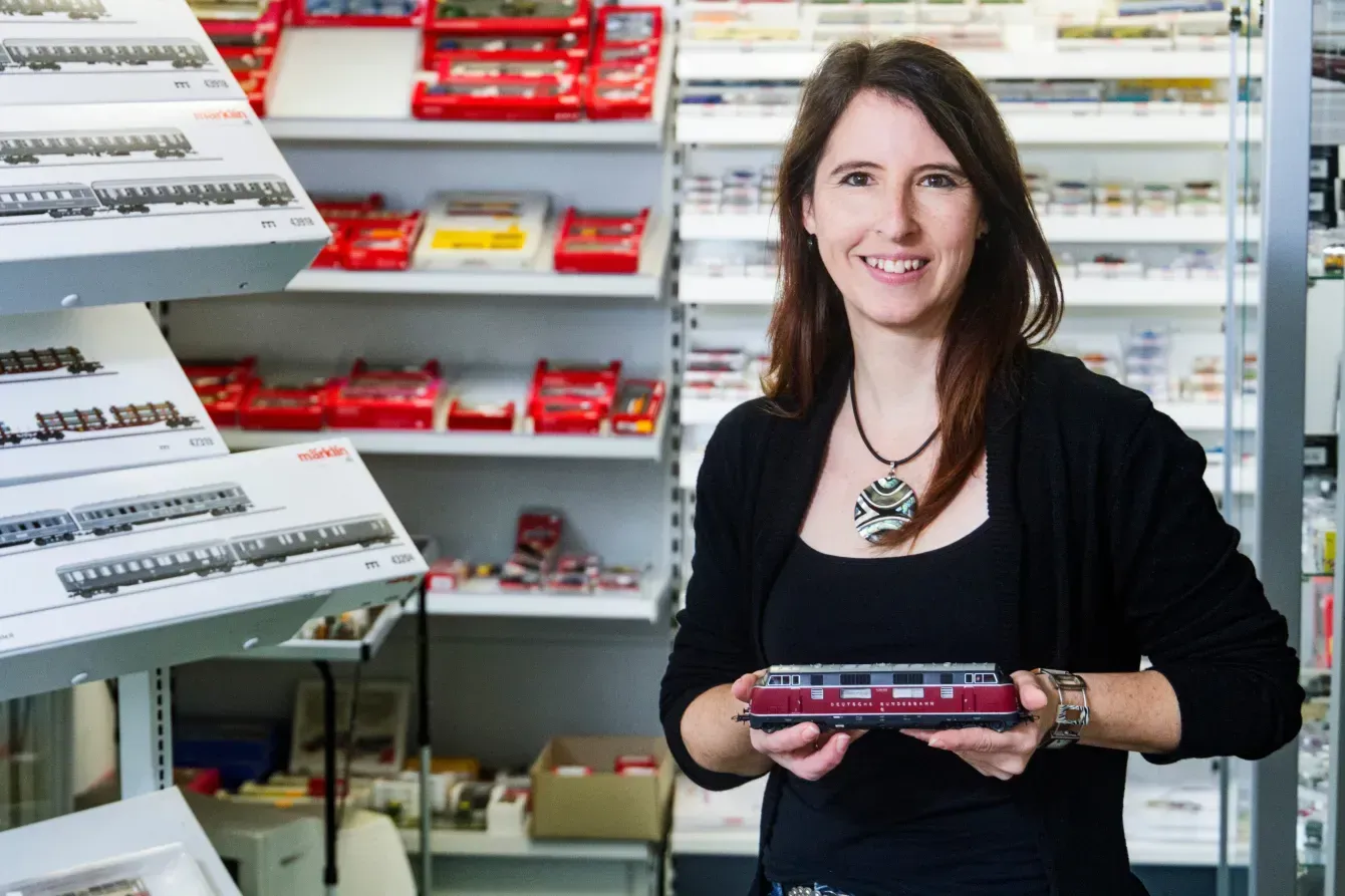 Woman holding model train
