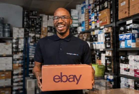Man smiling holding ebay cardboard box