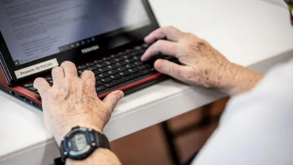 Person typing on keyboard