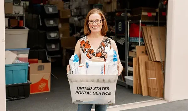 eBay seller holding USPS packages