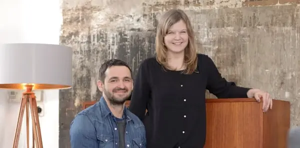 Middle-aged man and woman posed in front of modern furniture