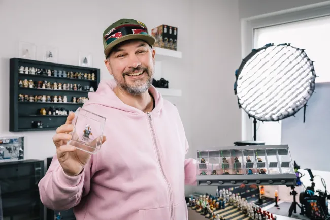 Man holding lego figurine in studio