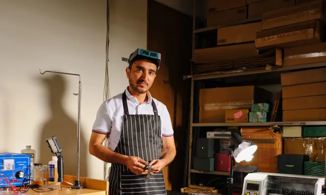 Man stanging in an apron in workshop