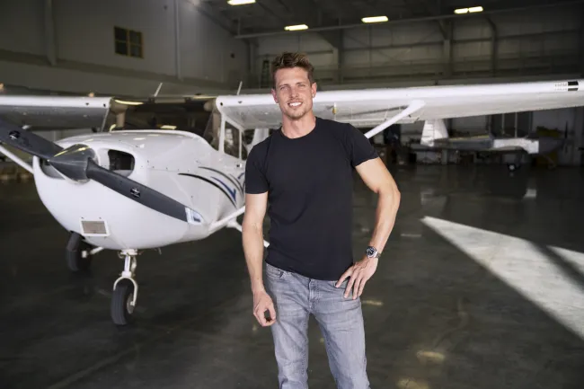 Alec Larson in front of airplane